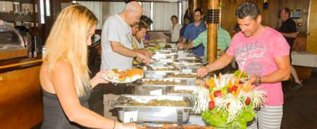 Passengers enjoying buffet lunch on an Athens day cruise to the Greek islands
