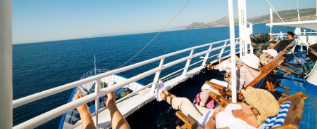 Passengers relaxing on the sun deck during an Athens day cruise in Greece