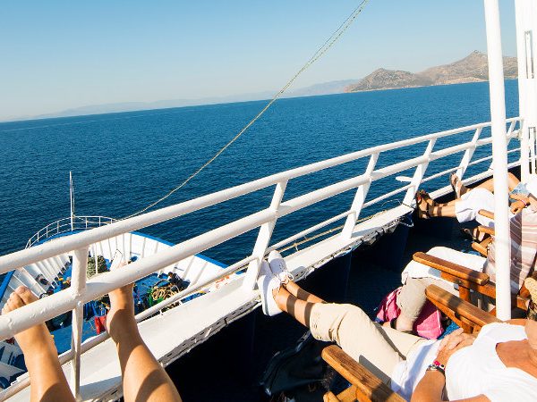 Passengers relaxing on the sun deck during an Athens day cruise in Greece